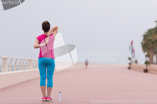 Image of woman stretching and warming up on the promenade