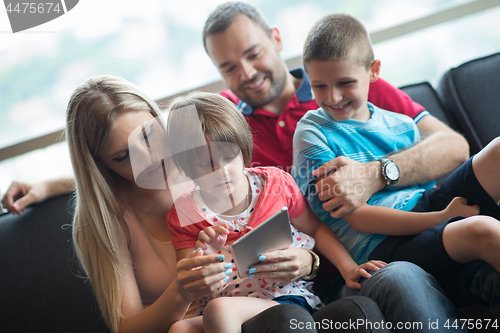 Image of happy young couple spending time with kids