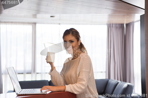 Image of woman drinking coffee enjoying relaxing lifestyle