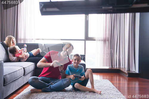 Image of Happy family playing a video game