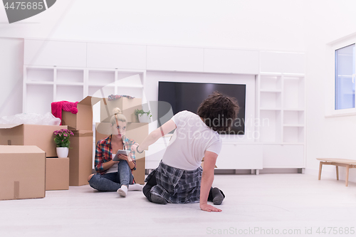 Image of young couple moving  in new house