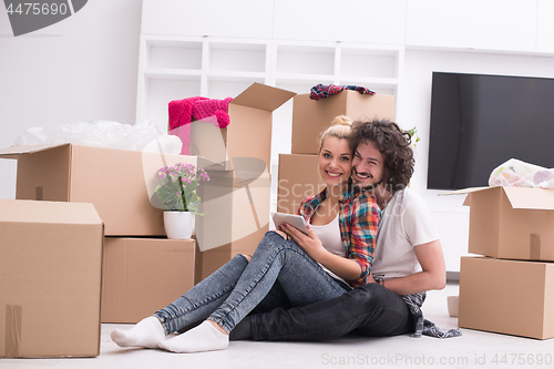 Image of young couple moving  in new house