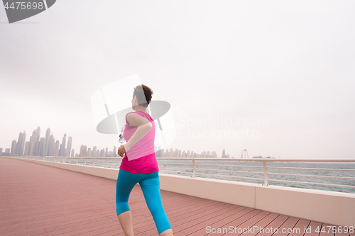 Image of woman running on the promenade