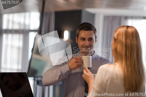 Image of A young couple is preparing for a job and using a laptop