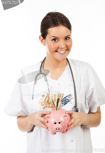 Image of happy woman doctor with piggy bank full of money