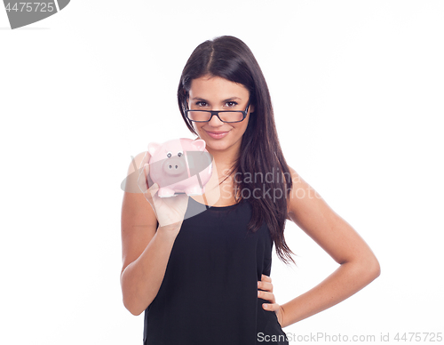 Image of Young woman with glasses happy with piggy bank