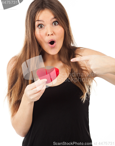 Image of young woman in love with a heart in hand