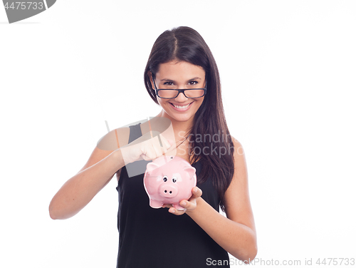 Image of Young woman with glasses happy with piggy bank