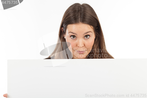 Image of Beautiful young woman showing blank signboard