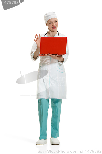 Image of Beautiful young woman in white coat posing at studio. Full length studio shot isolated on white.