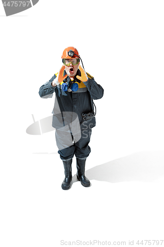 Image of The studio shot of senior bearded male miner standing at the camera on a white background.