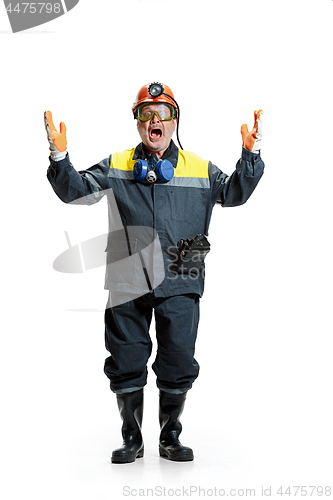 Image of The studio shot of senior bearded male miner standing at the camera on a white background.