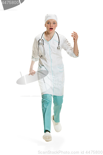 Image of Beautiful young woman in white coat posing at studio. Full length studio shot isolated on white.