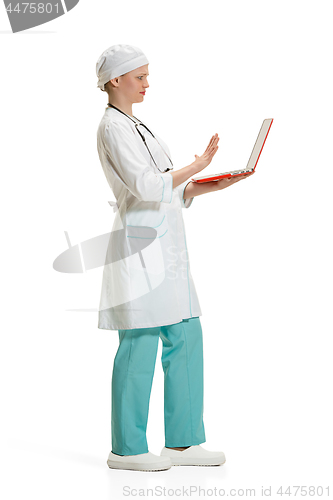 Image of Beautiful young woman in white coat posing at studio. Full length studio shot isolated on white.