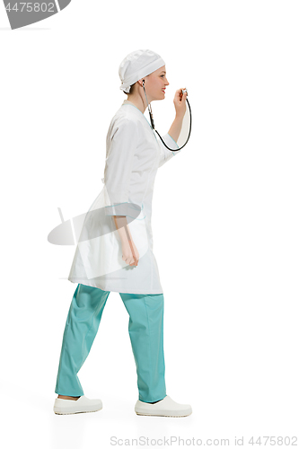 Image of Beautiful young woman in white coat posing at studio. Full length studio shot isolated on white.