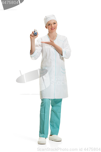 Image of Beautiful young woman in white coat posing at studio. Full length studio shot isolated on white.