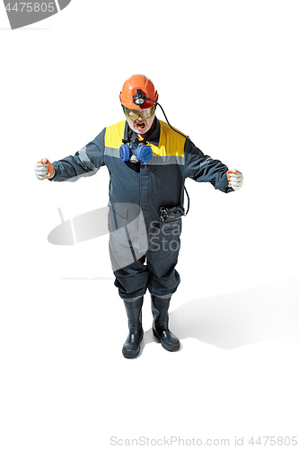 Image of The studio shot of senior bearded male miner standing at the camera on a white background.