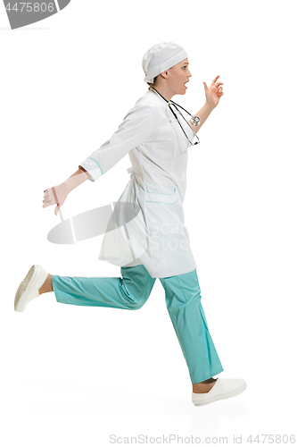 Image of Beautiful young woman in white coat posing at studio. Full length studio shot isolated on white.
