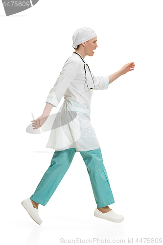 Image of Beautiful young woman in white coat posing at studio. Full length studio shot isolated on white.
