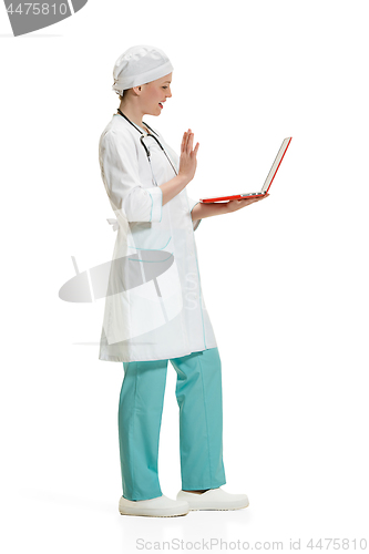 Image of Beautiful young woman in white coat posing at studio. Full length studio shot isolated on white.