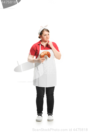 Image of Portrait of cute smiling woman with pastries in her hands in the studio, isolated on white background