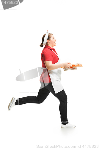 Image of Portrait of cute smiling woman with pastries in her hands in the studio, isolated on white background