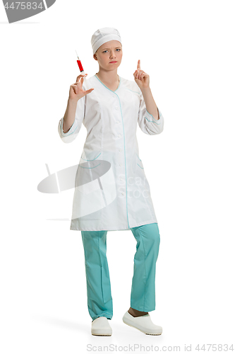 Image of beautiful young woman doctor in medical robe holding syringe in hand.