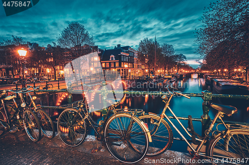 Image of Amterdam canal, bridge and medieval houses in the evening