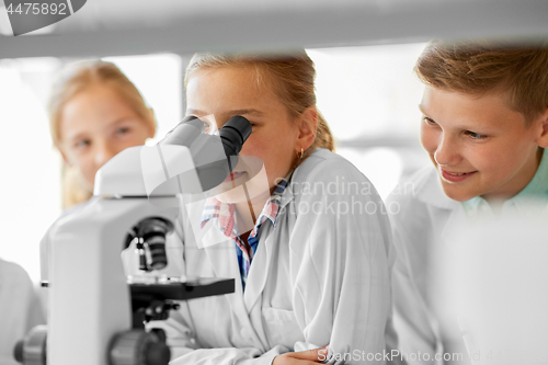 Image of kids or students with microscope biology at school