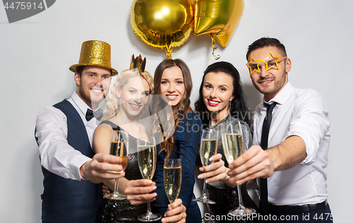 Image of happy friends with champagne glasses at party