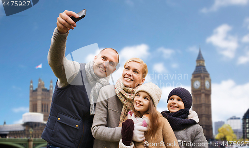 Image of family taking selfie by smartphone in london city