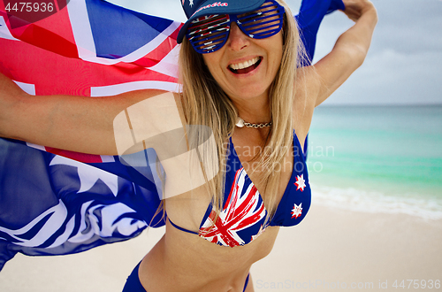 Image of Fun loving woman waving proudly the Australian Flag