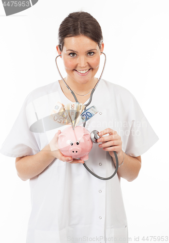 Image of happy woman doctor with piggy bank full of money