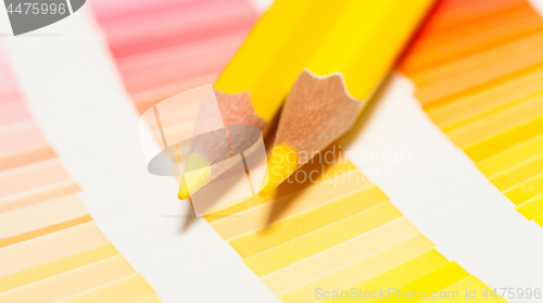 Image of yellow colored pencils and color chart of all colors