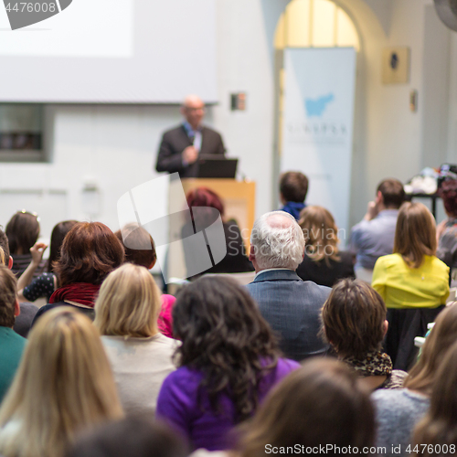 Image of Man giving presentation in lecture hall at university.