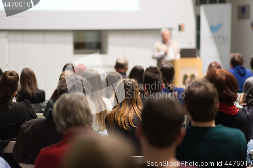 Image of Man giving presentation in lecture hall at university.