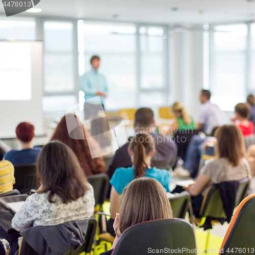 Image of Speaker giving presentation on business conference.