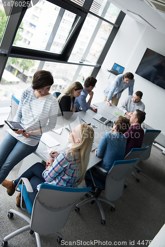 Image of Pretty Businesswomen Using Tablet In Office Building during conf