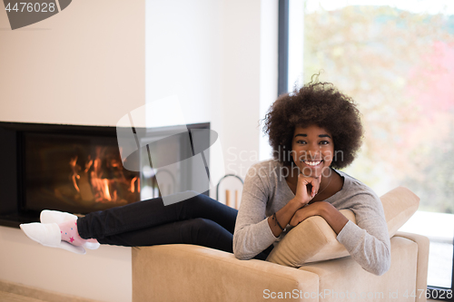 Image of black woman in front of fireplace