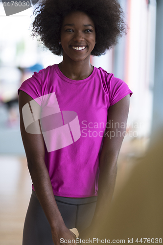 Image of woman working out in a crossfit gym with dumbbells