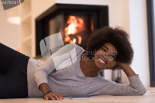 Image of black women using tablet computer on the floor