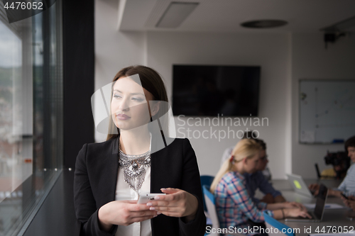 Image of Business Girl Standing In A Modern Building Near The Window With