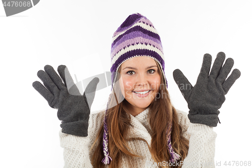 Image of Face of pretty woman with gloves and knitted winter cap  with smile