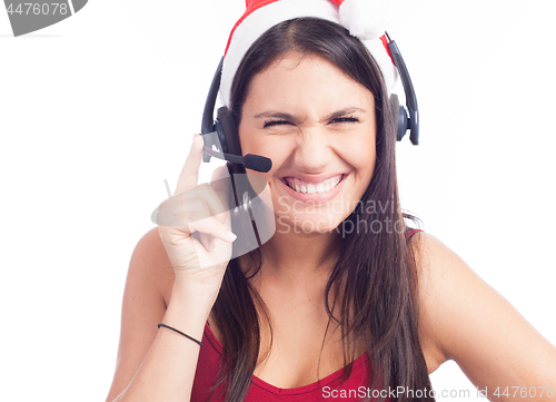 Image of Pretty phone operator in Santa hat isolated over white