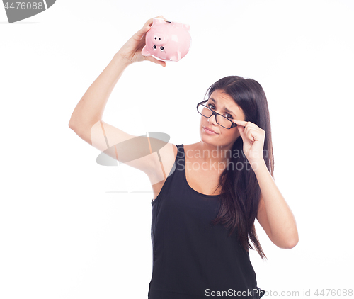 Image of Young woman worried with a piggy bank