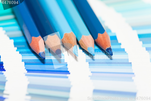 Image of blue colored pencils and color chart of all colors