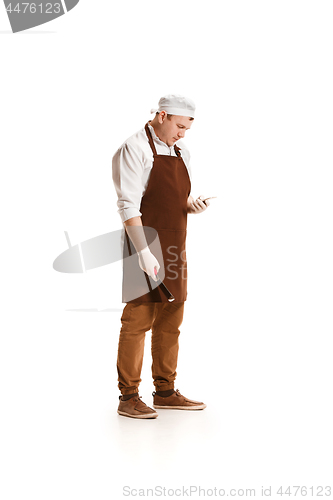 Image of Serious butcher posing with a cleaver isolated on white background