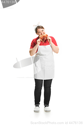 Image of Portrait of cute smiling woman with pastries in her hands in the studio, isolated on white background