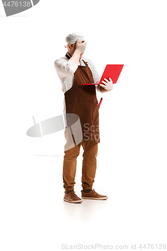 Image of Sorry butcher posing with a laptop isolated on white background