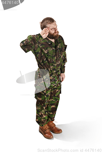 Image of Young army soldier wearing camouflage uniform isolated on white